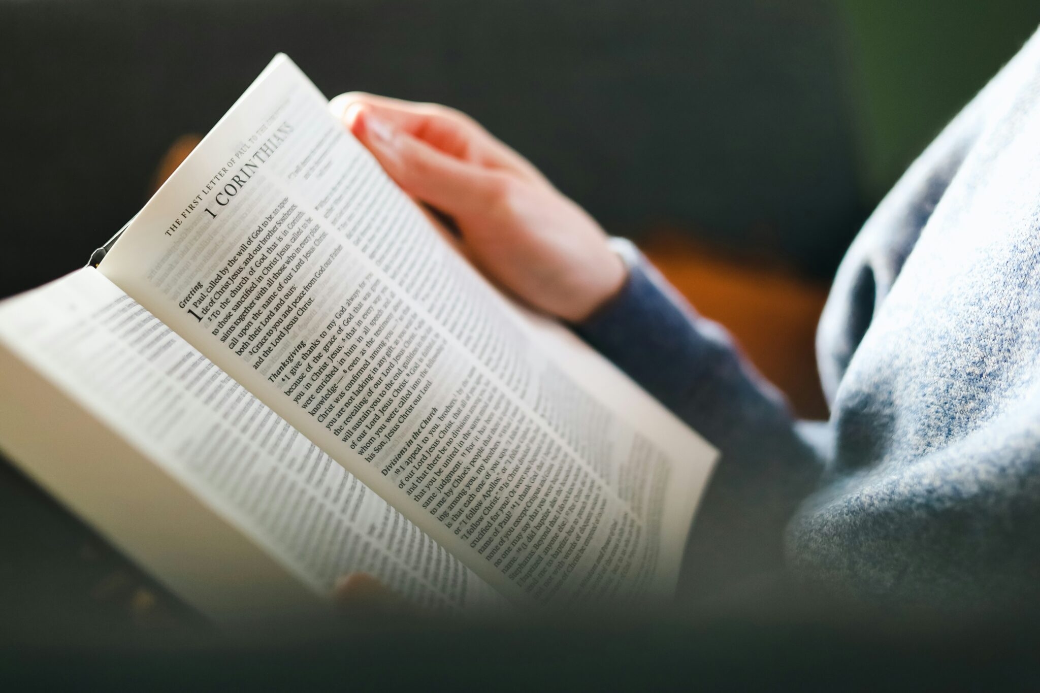 a person reading a book on a couch